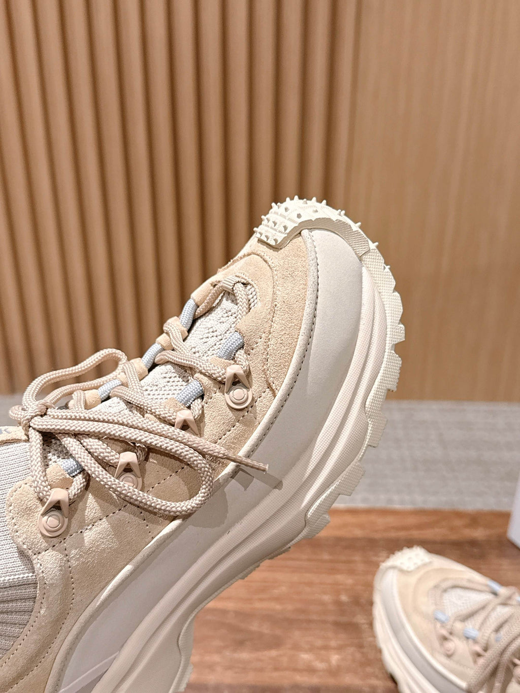 Moncler beige sneaker close-up of upper, laces, and textured trim.