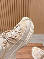 Moncler beige sneaker close-up of upper, laces, and textured trim.