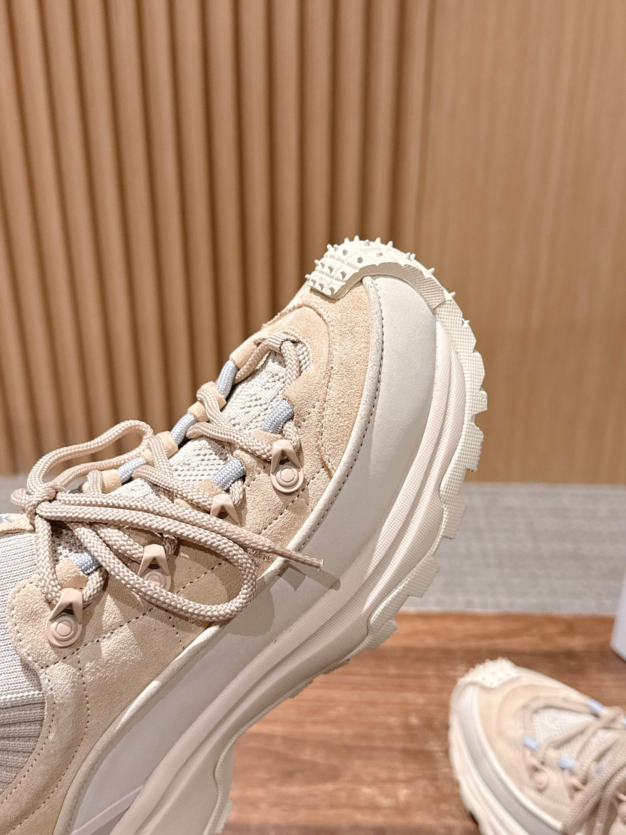 Moncler beige sneaker close-up of upper, laces, and textured trim.