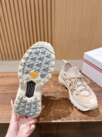 Moncler beige sneaker outsole close-up with laces and tread texture visible.
