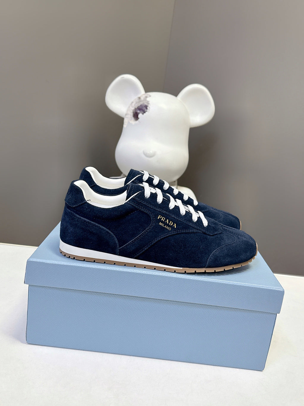 Prada unisex suede sneakers in dark blue with white lace-up, gum sole.