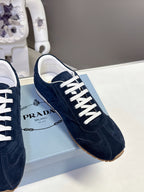 Prada dark blue suede sneakers, white lace-up and PRADA logo detail on box.