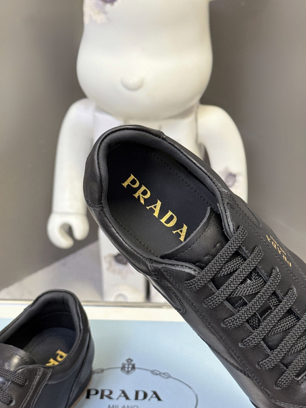 Black leather sneaker with PRADA logo on inner lining, lace-up front