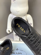 Black leather sneaker with PRADA logo on inner lining, lace-up front