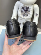 Black leather sneakers, heel PRADA lettering and low gum rubber sole