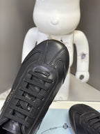 Black leather lace-up sneaker with stitched panels and PRADA logo on insole