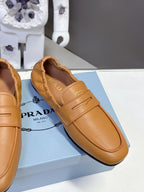 Prada tan leather loafer with strap detail, stitched apron and curved toe