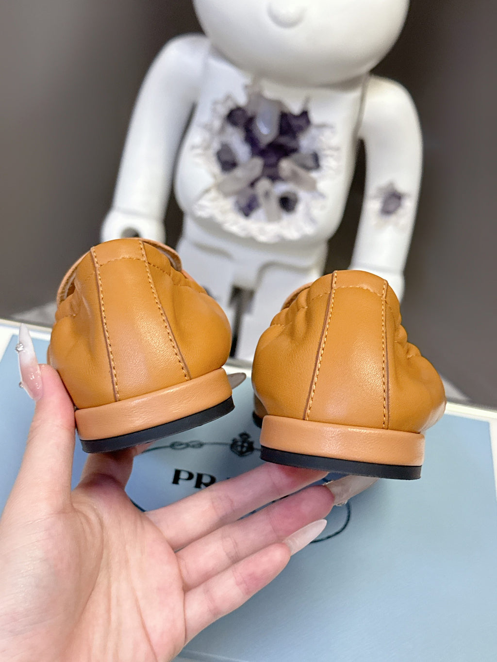 Prada tan leather loafers, back view with low sole and seam detail