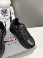 Prada unisex sneakers, black leather upper with PRADA logo on the side