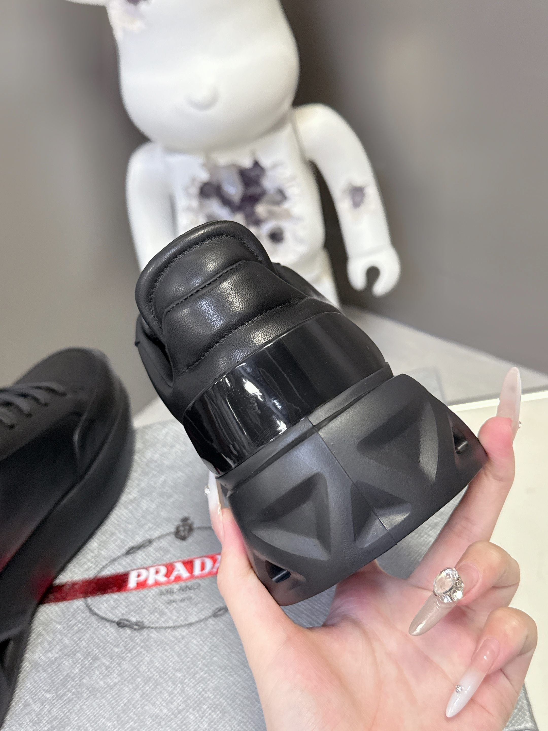 Prada unisex sneakers, black rubber heel with glossy strap detail
