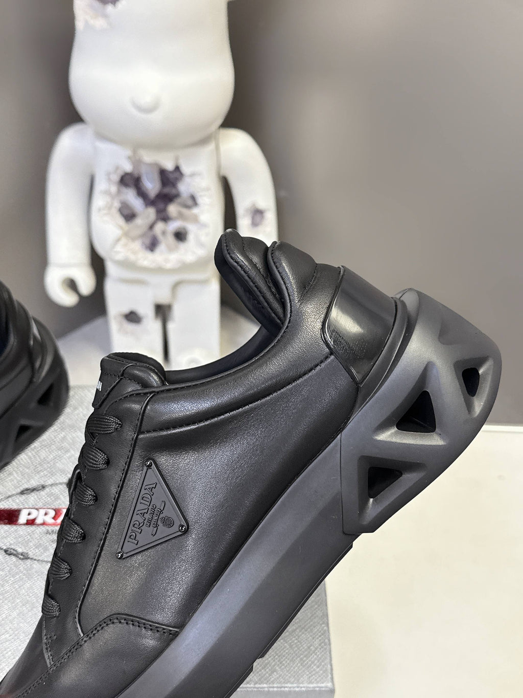 Prada unisex sneakers, black leather upper with textured sole and side emblem