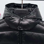 Moncler puffer jacket hooded inner layer close-up, dark color with snap buttons