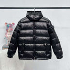 Moncler long puffer jacket in dark color, full-zip with stand collar and quilted panels