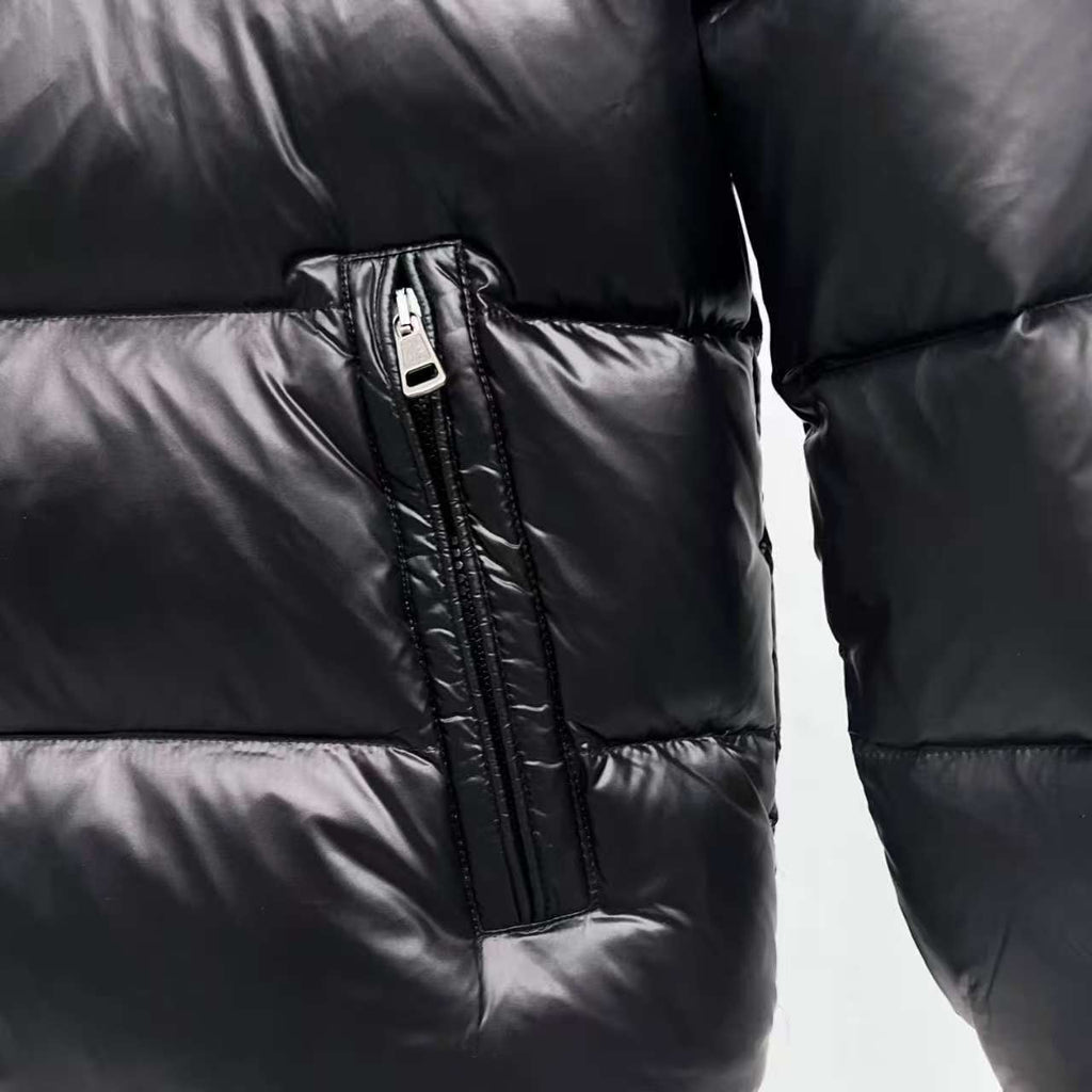 Moncler puffer jacket close-up, dark color, vertical zipper pocket detail