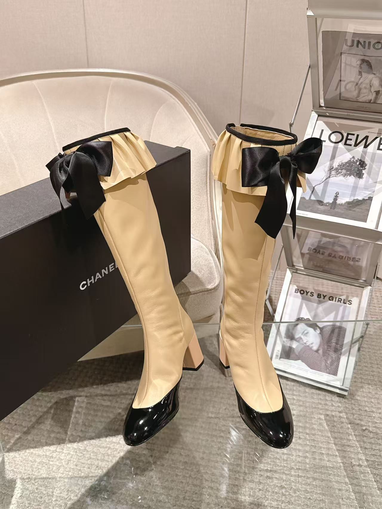 Chanel ladies’ knee-high boots with cream leather-look upper and black bow