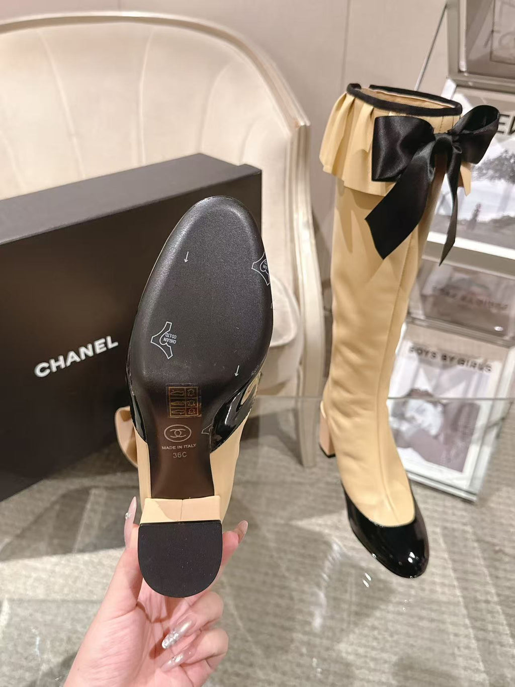Chanel ladies’ boots pair: cream shafts with black soles and toe caps
