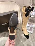 Chanel ladies’ boots pair: cream shafts with black soles and toe caps