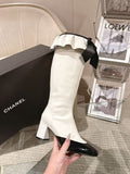 Chanel ladies high-heel boots in white leather with black patent toe and bow detail
