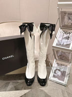 Chanel knee-high boots set, white leather with black ribbon bows and glossy black heels