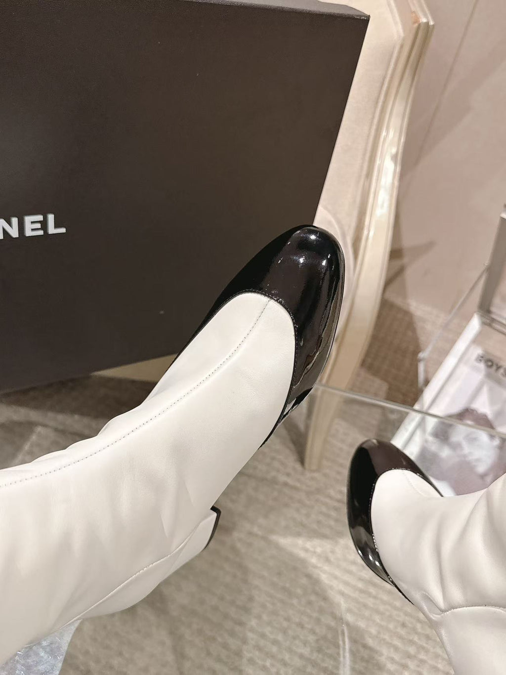 Chanel white knee-high boots with black patent toe and curved heel