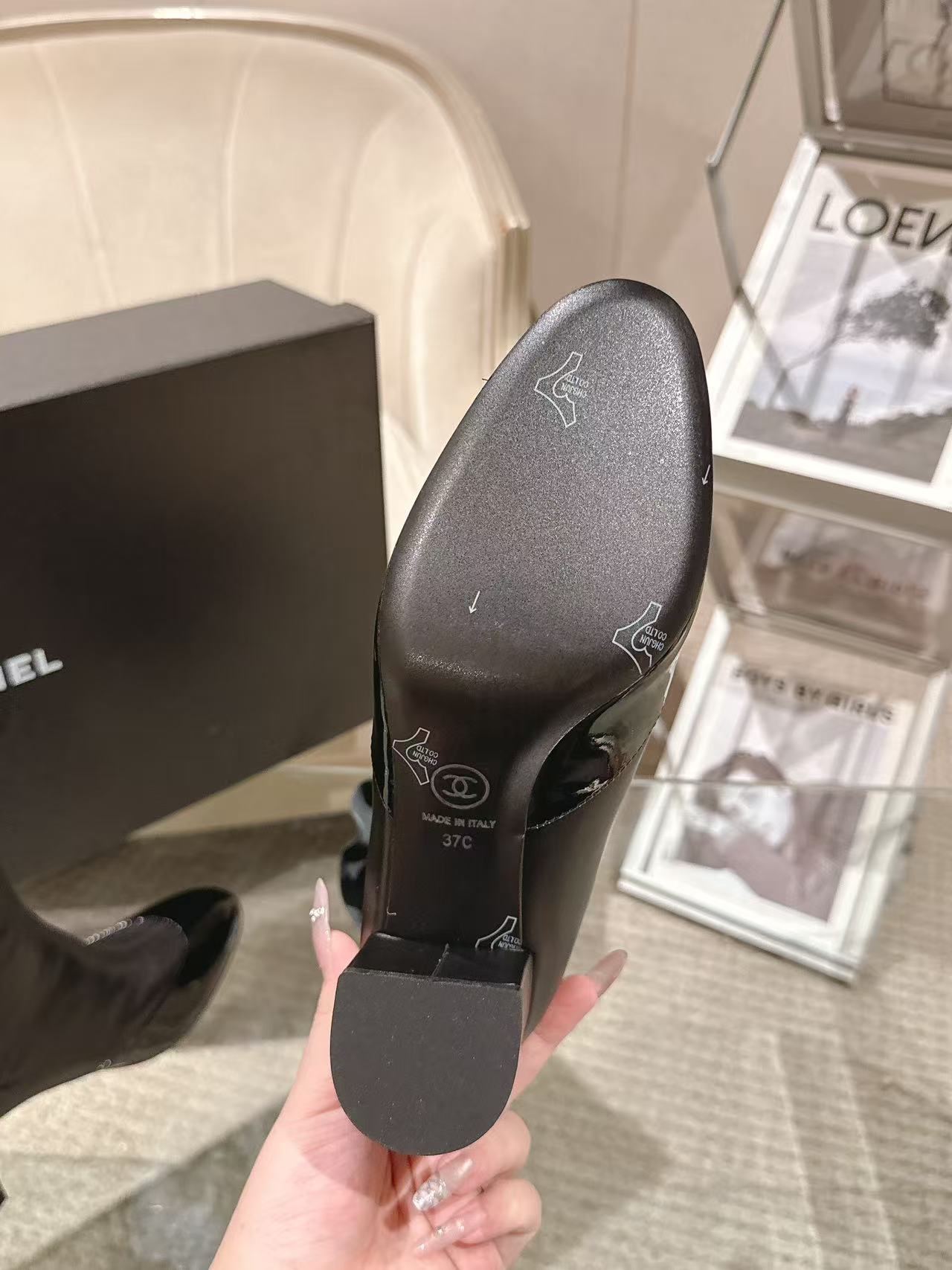 Boot sole view with printed logo marks and textured tread