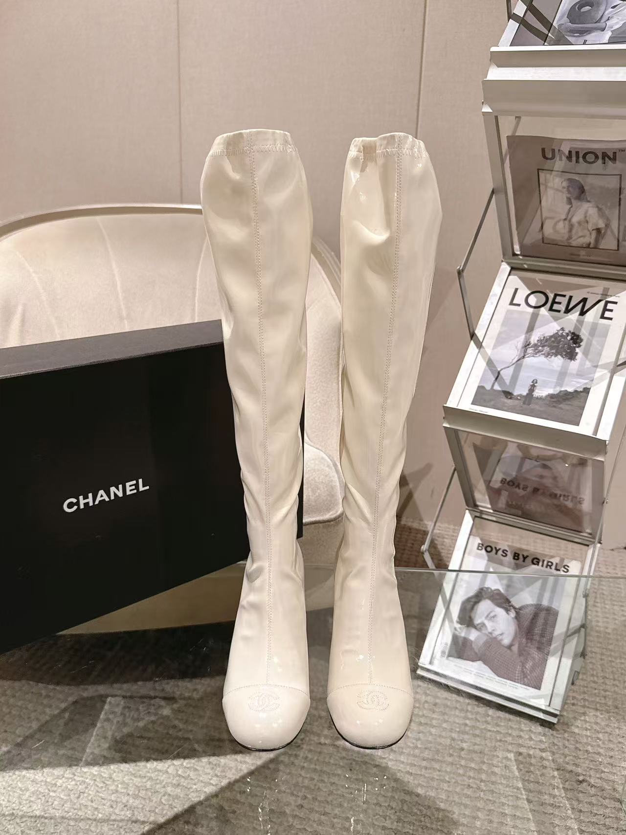 Pair of Chanel knee-high boots in light white patent leather, pointed toe