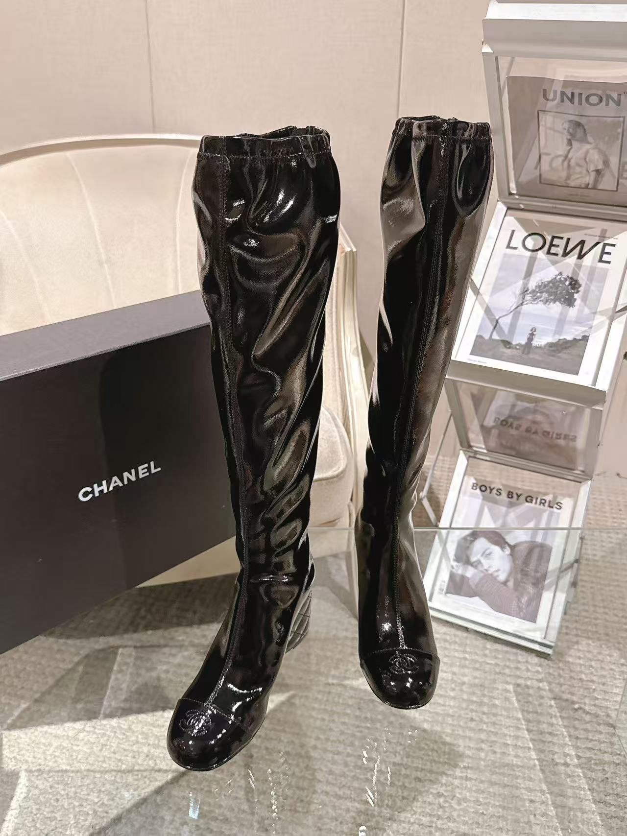 Chanel black patent leather knee-high boots, front view with pointed toe