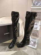 Chanel black patent leather knee-high boots, side view with pull-on shaft