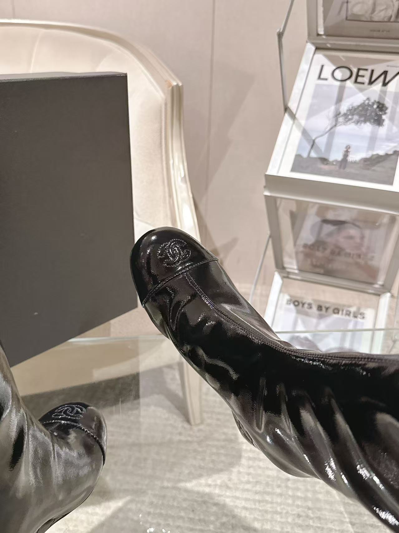 Chanel black patent leather knee-high boot, close-up side profile and low heel