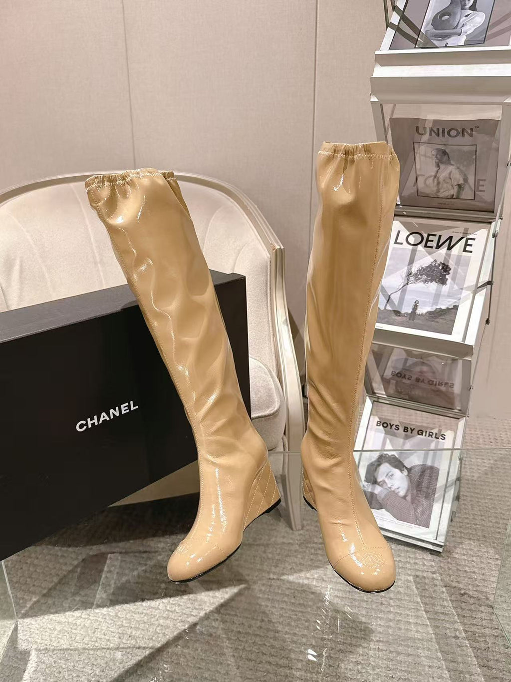 Chanel glossy beige knee-high boots with slim heel, angled view