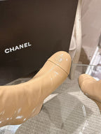 Chanel glossy beige knee-high boot, seam detail and rounded toe close-up