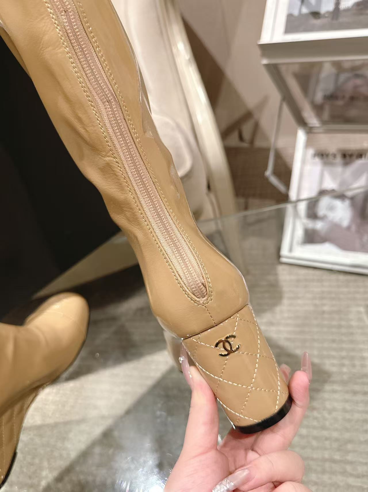 Chanel glossy beige knee-high boot, heel and emblem stitching close-up