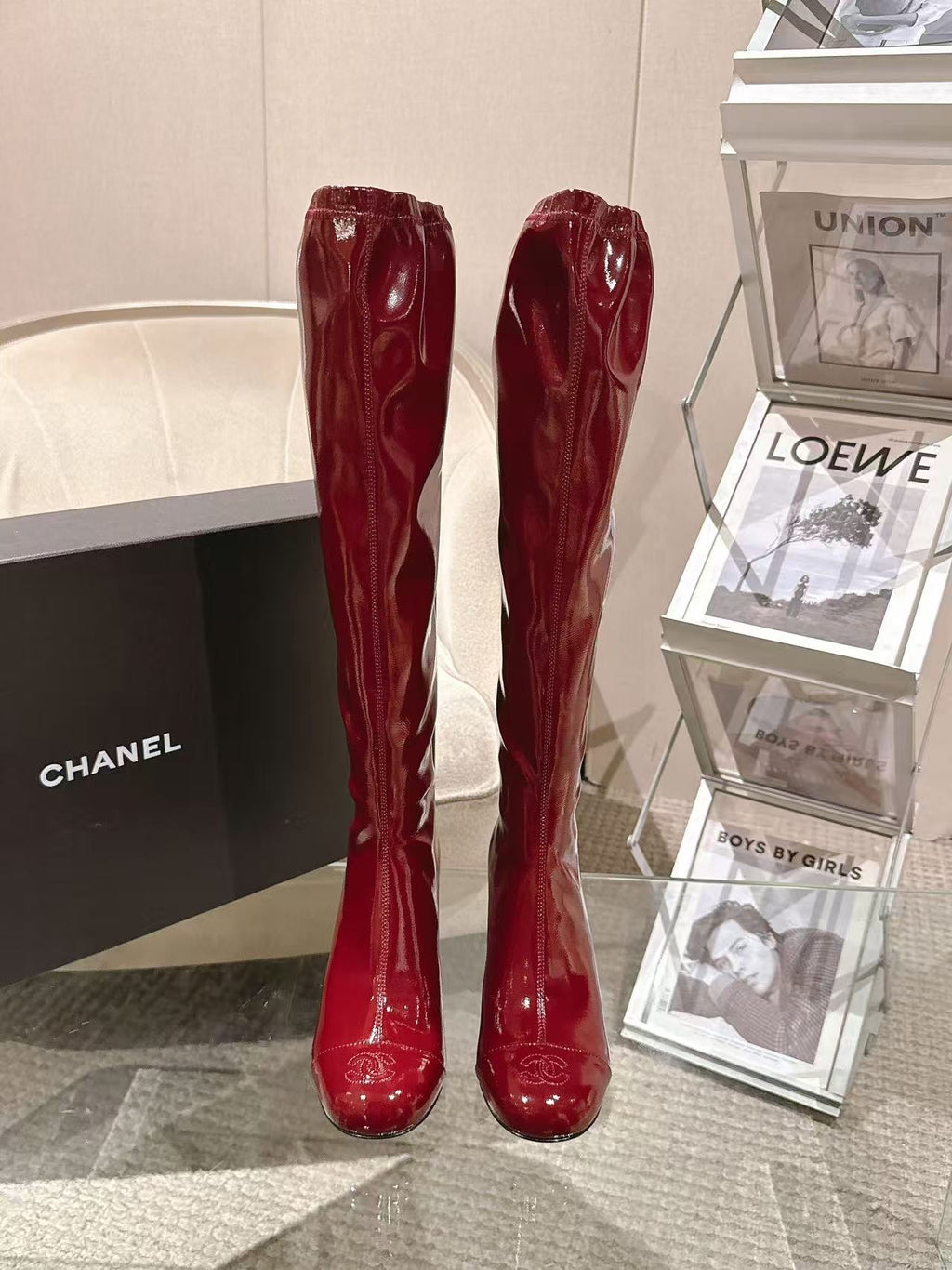 Red patent leather knee boots with glossy finish, pair