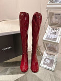 Red patent leather knee boots with glossy finish, pair