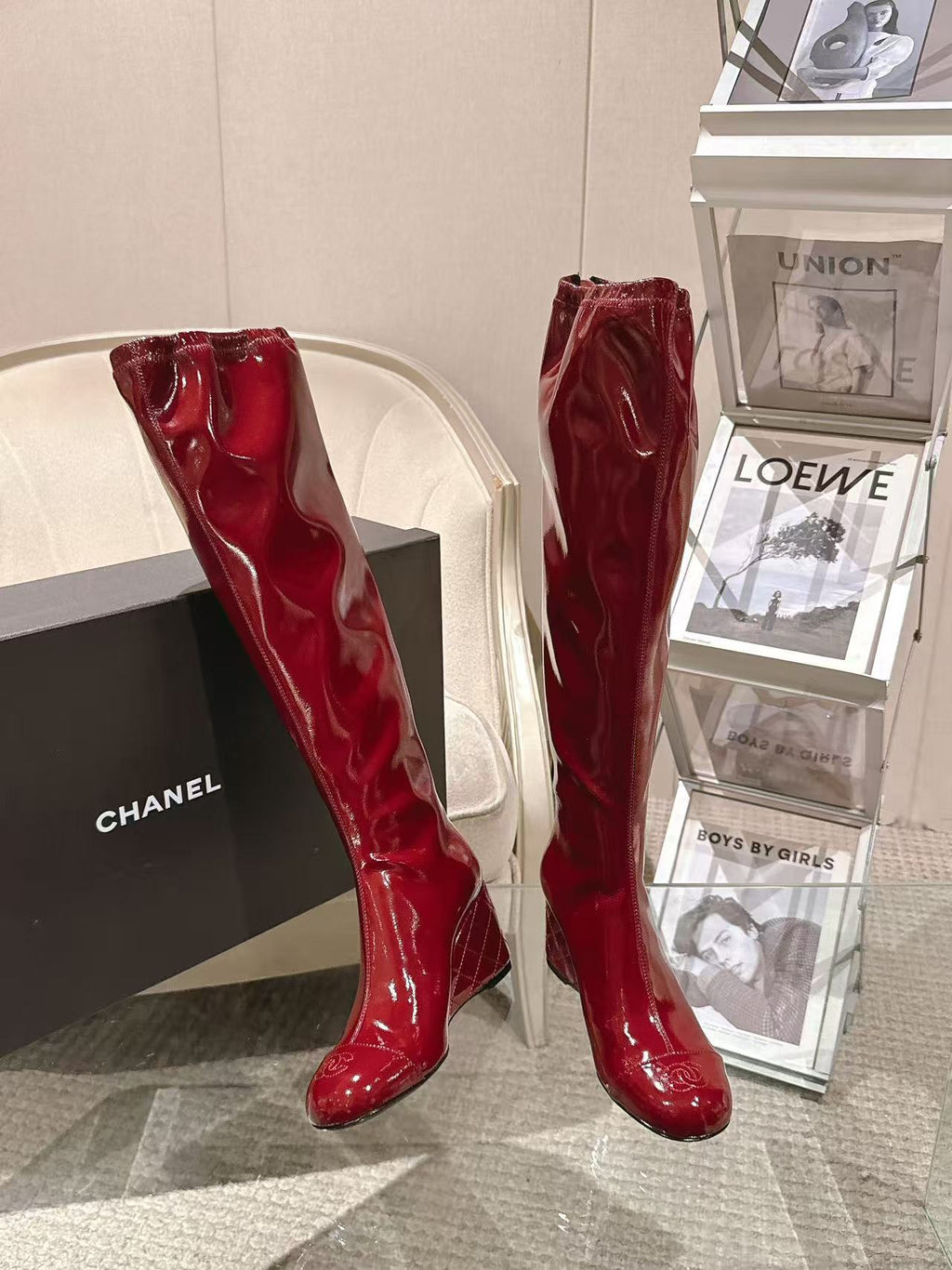 Red patent leather knee boots, angled view with slim silhouette