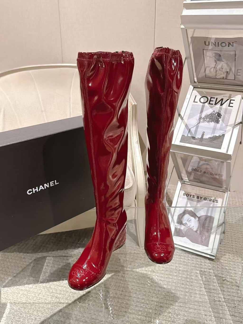 Red patent leather knee boots standing side by side