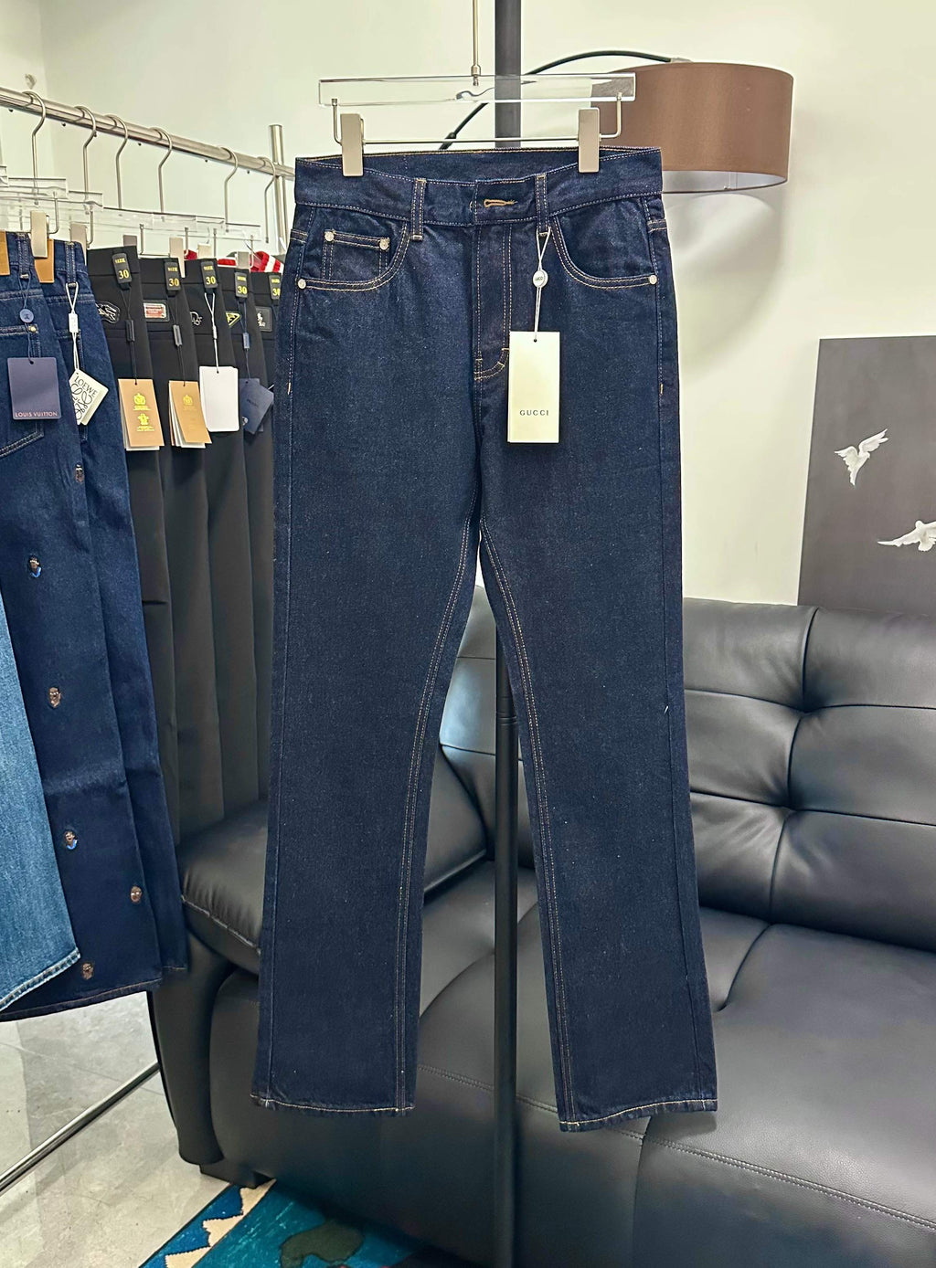 Dark blue denim jeans with rose embroidery and hanging white tag