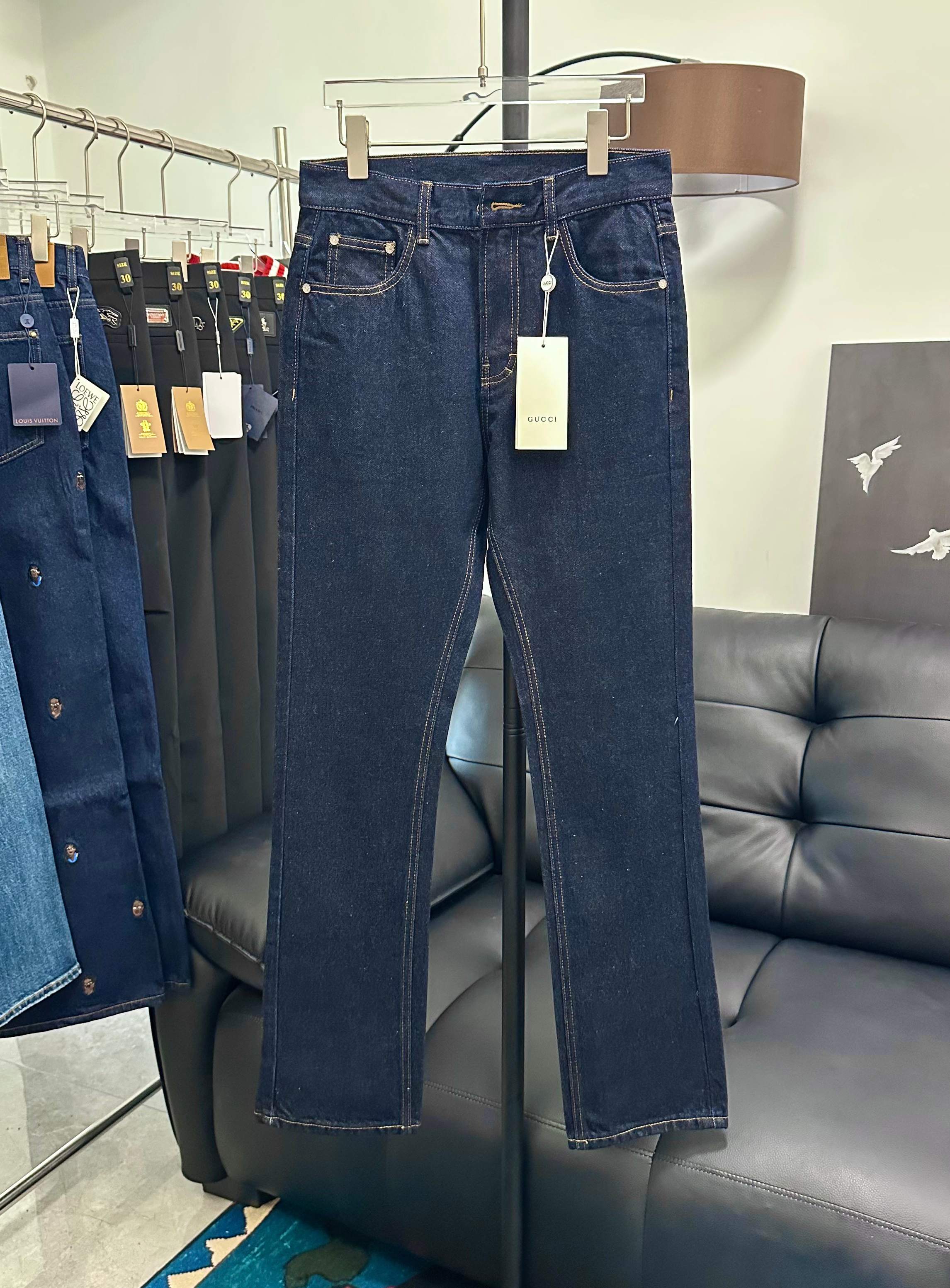 Dark blue denim jeans with rose embroidery and hanging white tag