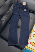 Dark blue denim jeans with rose embroidered back pocket and GUCCI tag