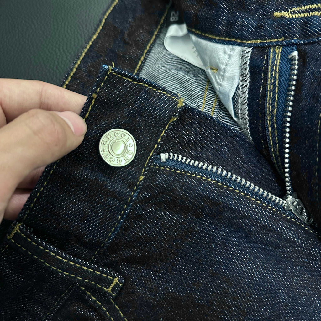 Denim jeans pocket with metal button and zipper trim detail