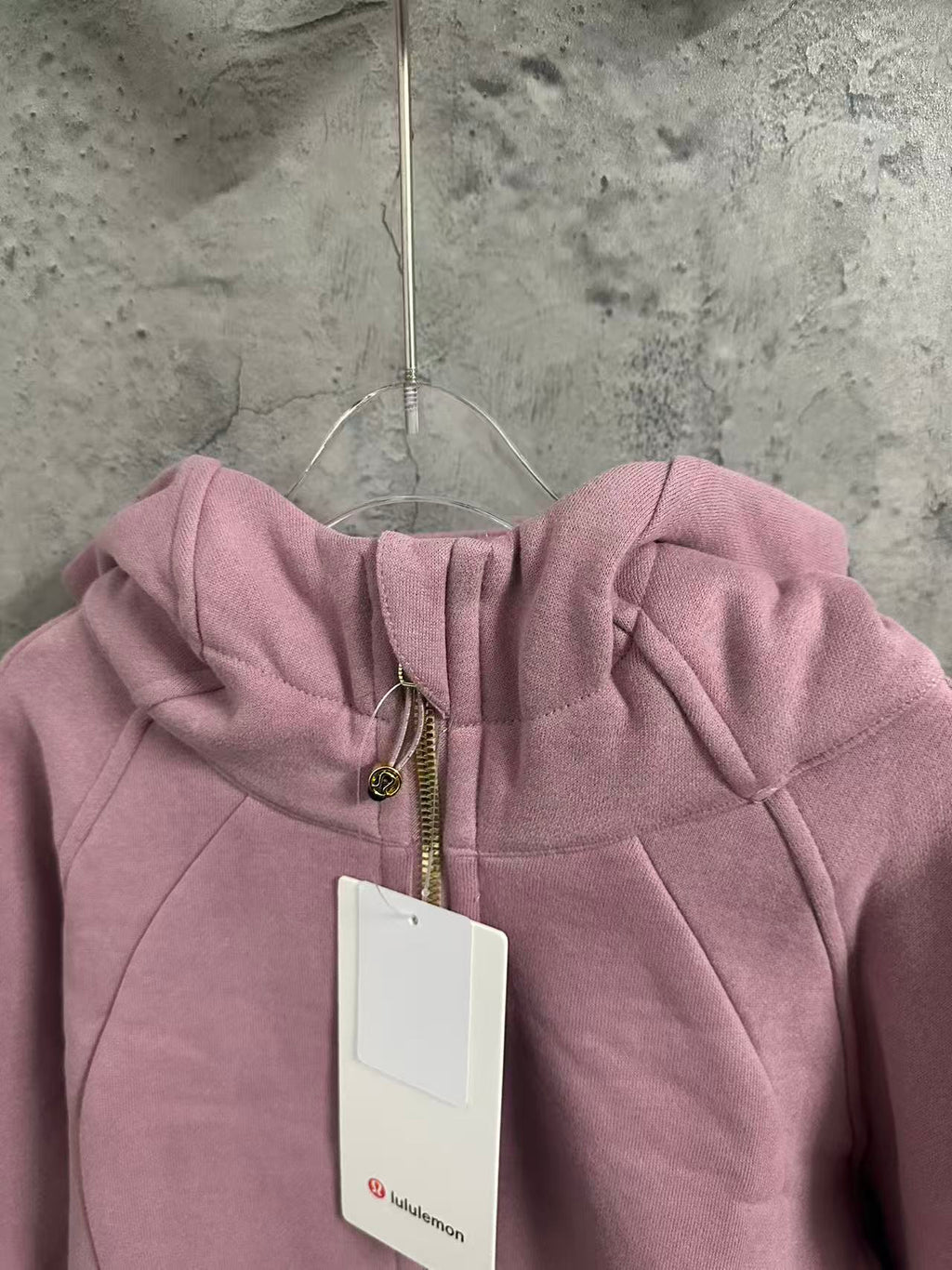 Dusty pink zip-up hoodie hood with drawcord and front zipper detail