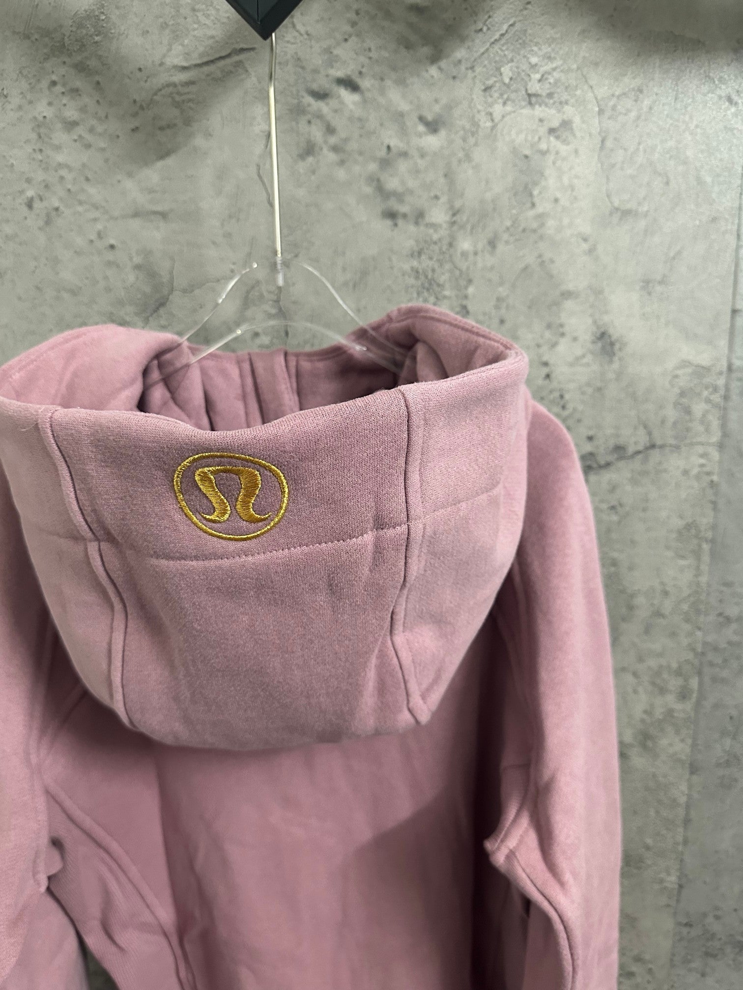 Pink hoodie back hood with small oval logo patch