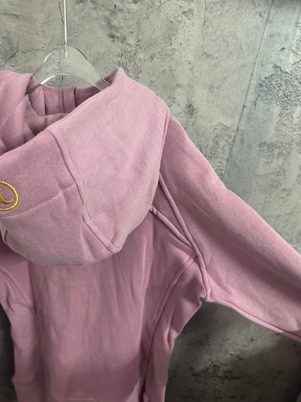 Pink hoodie back view showing shoulder yoke and hood area