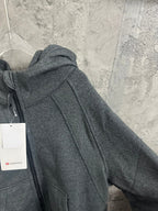 Heather gray zip-up hoodie sleeve and hood detail with hanging tag