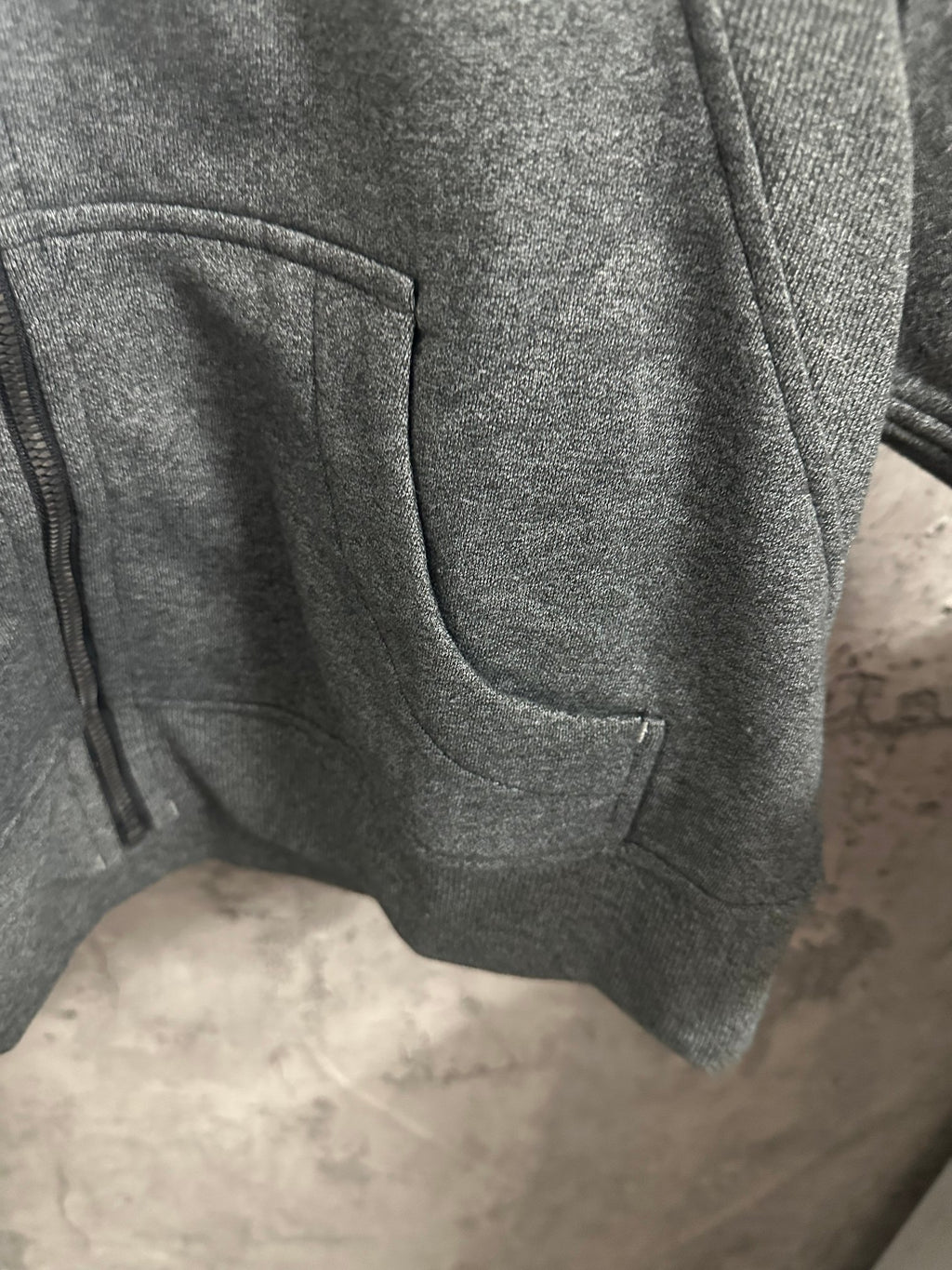 Dark gray hoodie with side pocket and curved front panel