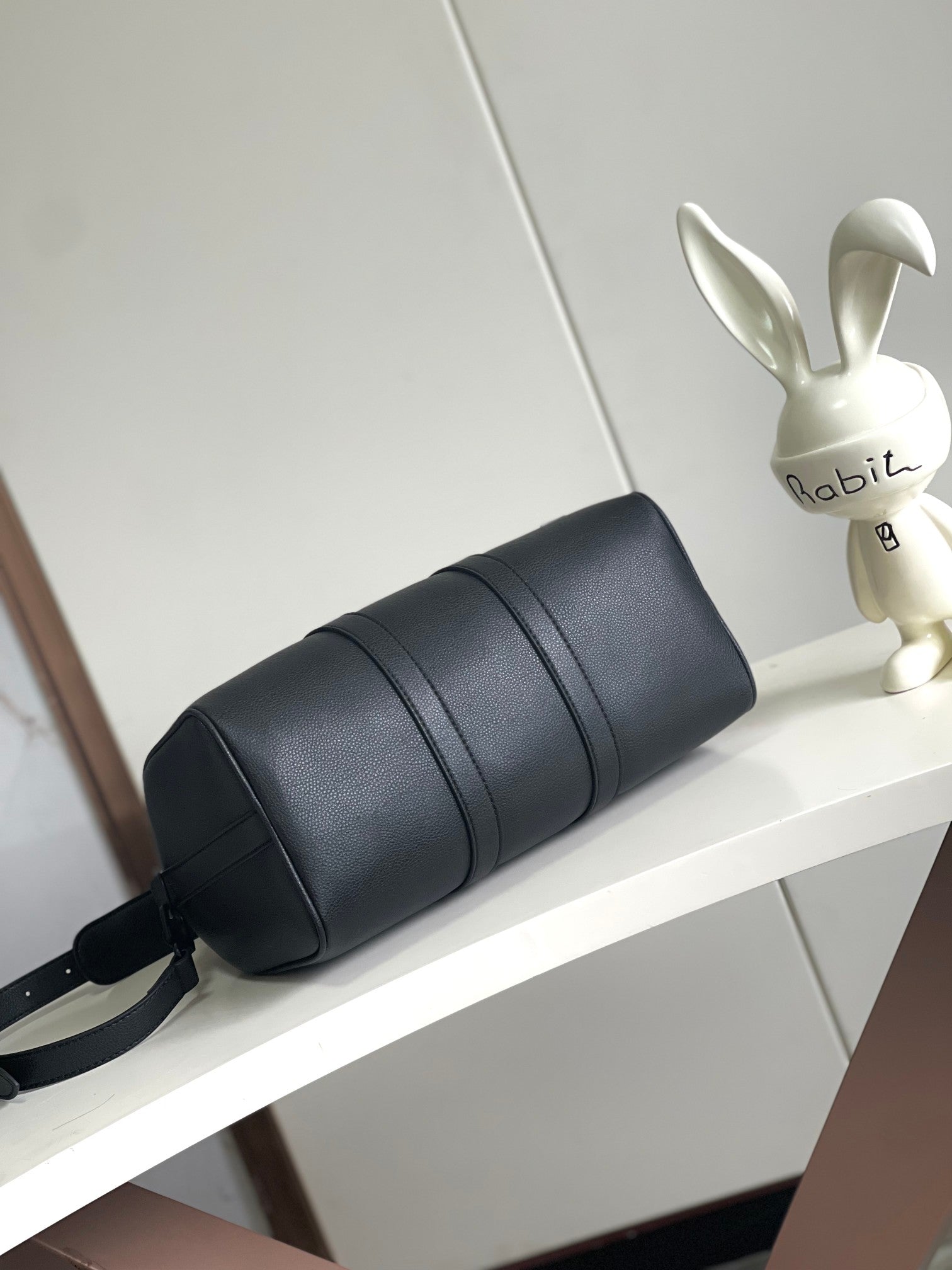 Louis Vuitton barrel bag with front panel bands and attached shoulder strap
