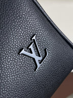 Louis Vuitton logo plate on textured dark navy leather bag