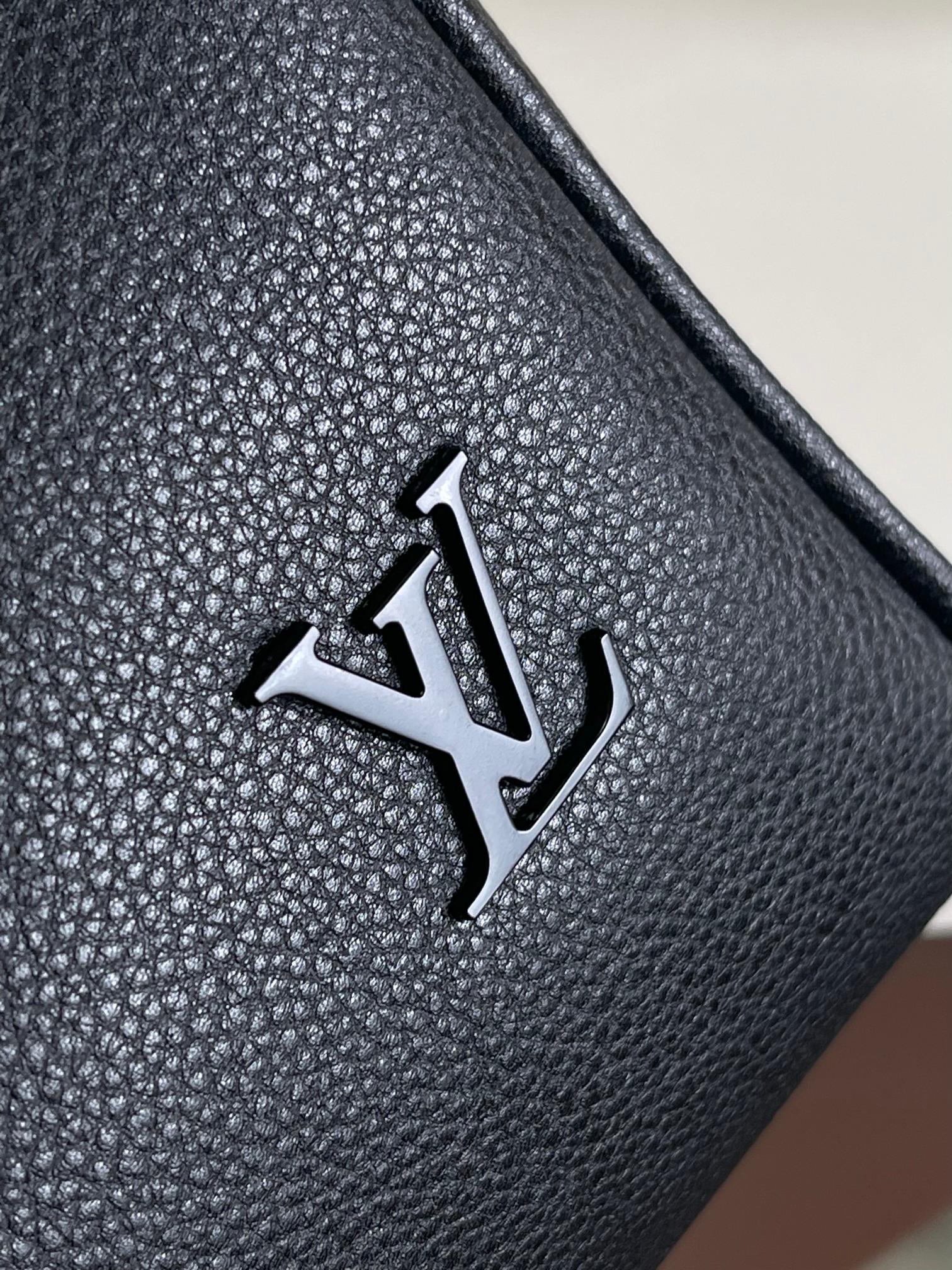 Louis Vuitton logo plate on textured dark navy leather bag