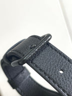 Louis Vuitton bag handle detail with engraved leather pull tab