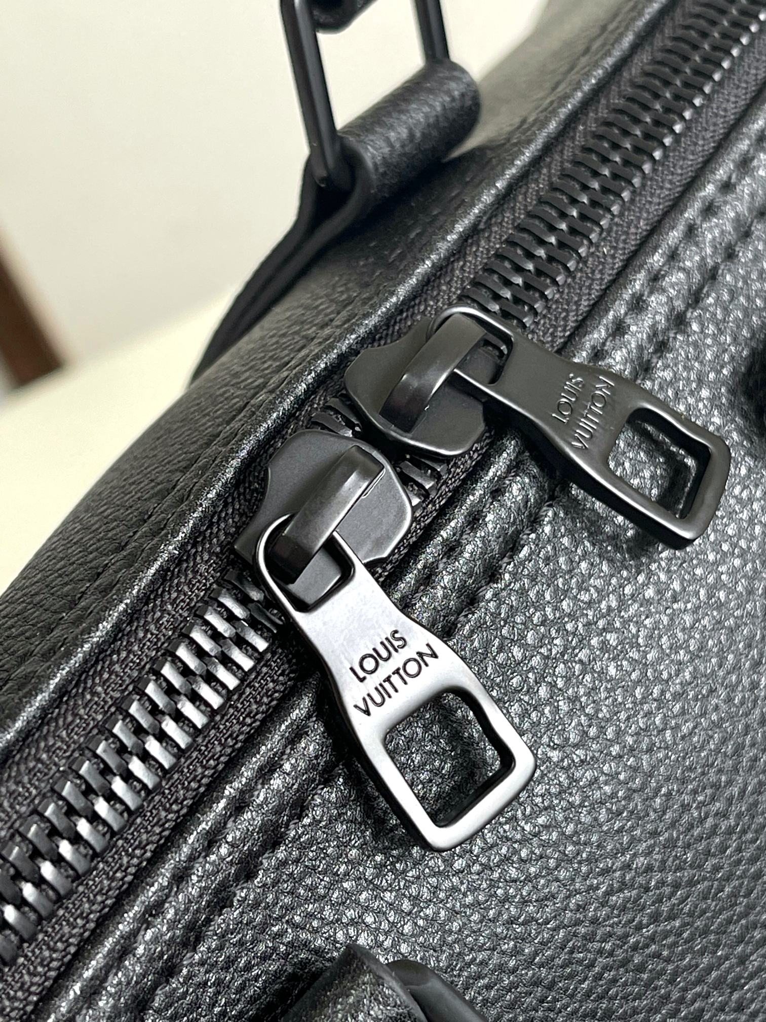 Louis Vuitton bag zipper pulls and logo hardware on textured leather